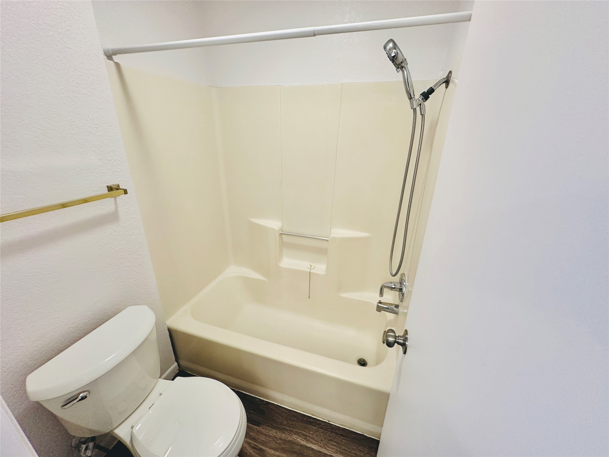 1002 Ridgemont Street Round Rock, TX 78664 - Photo 30 of 30 Full bathroom featuring tub / shower combination, a textured wall, and wood finished floors