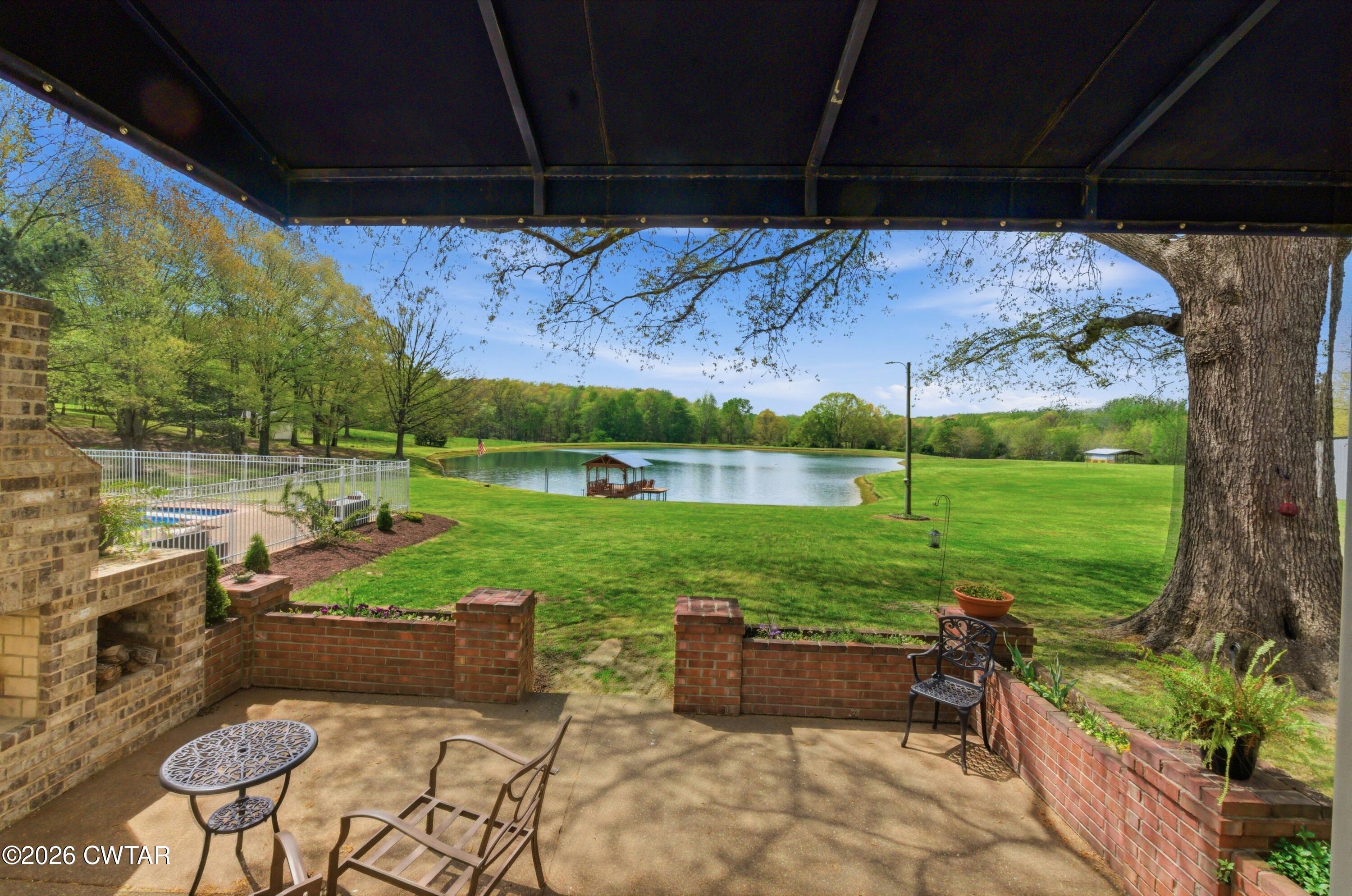 2757 Edward Williams Road Gadsden, TN 38337 - Photo 14 of 51 a view of a patio with table and chairs under an umbrella