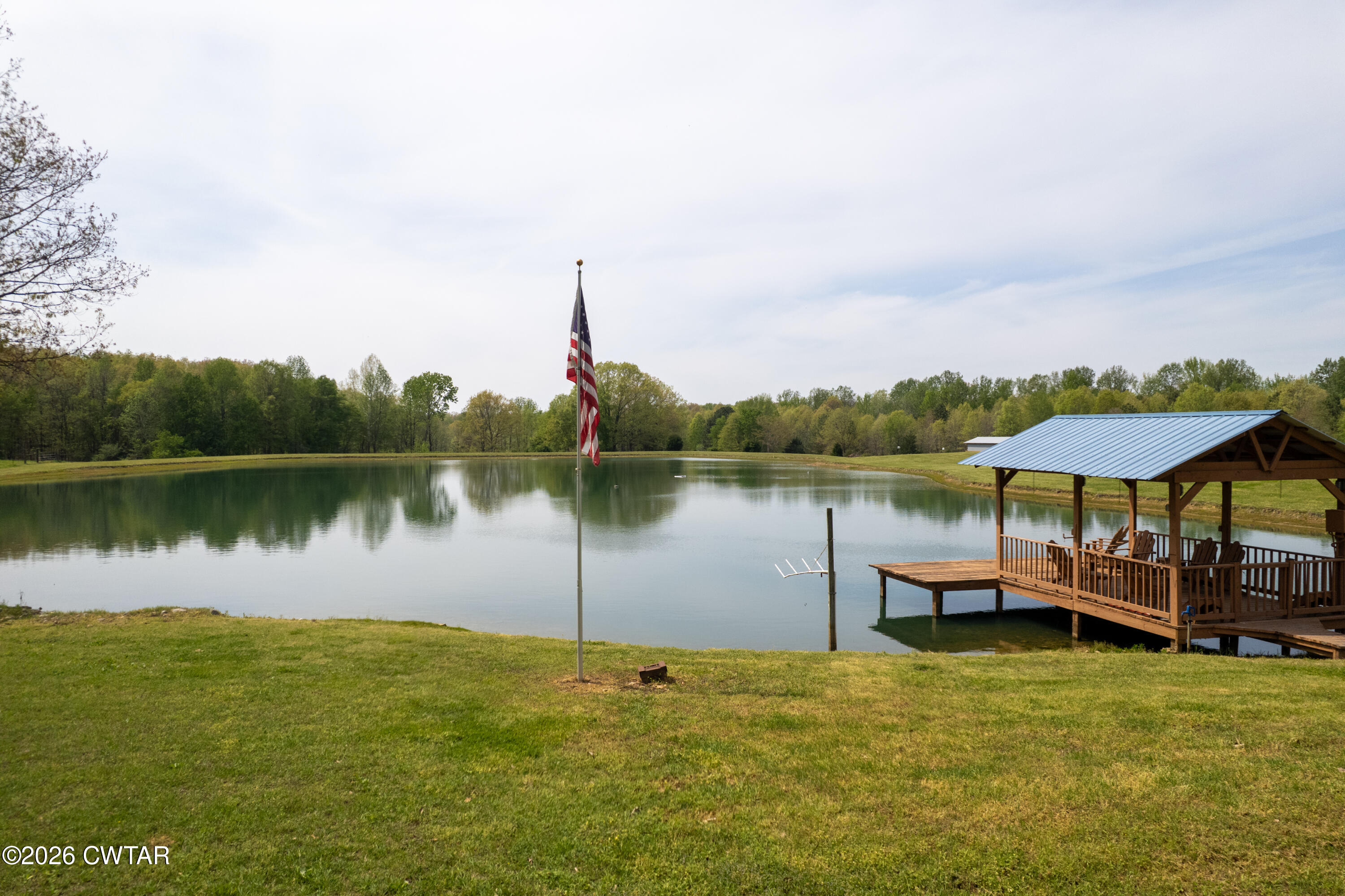 2757 Edward Williams Road Gadsden, TN 38337 - Photo 17 of 51 a view of a lake with a table and chairs