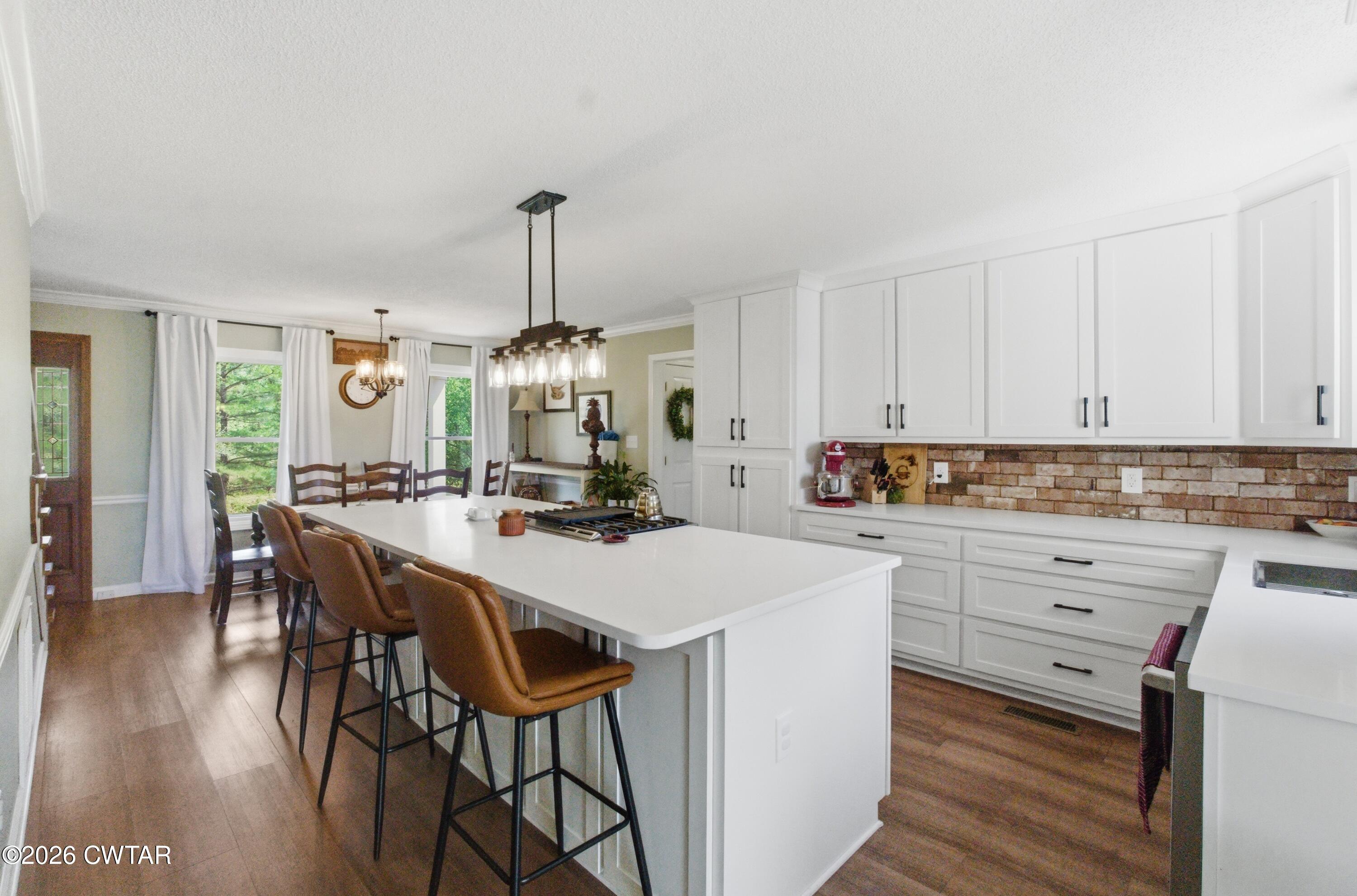 2757 Edward Williams Road Gadsden, TN 38337 - Photo 26 of 51 a kitchen with appliances a island a stove a table and chairs in it