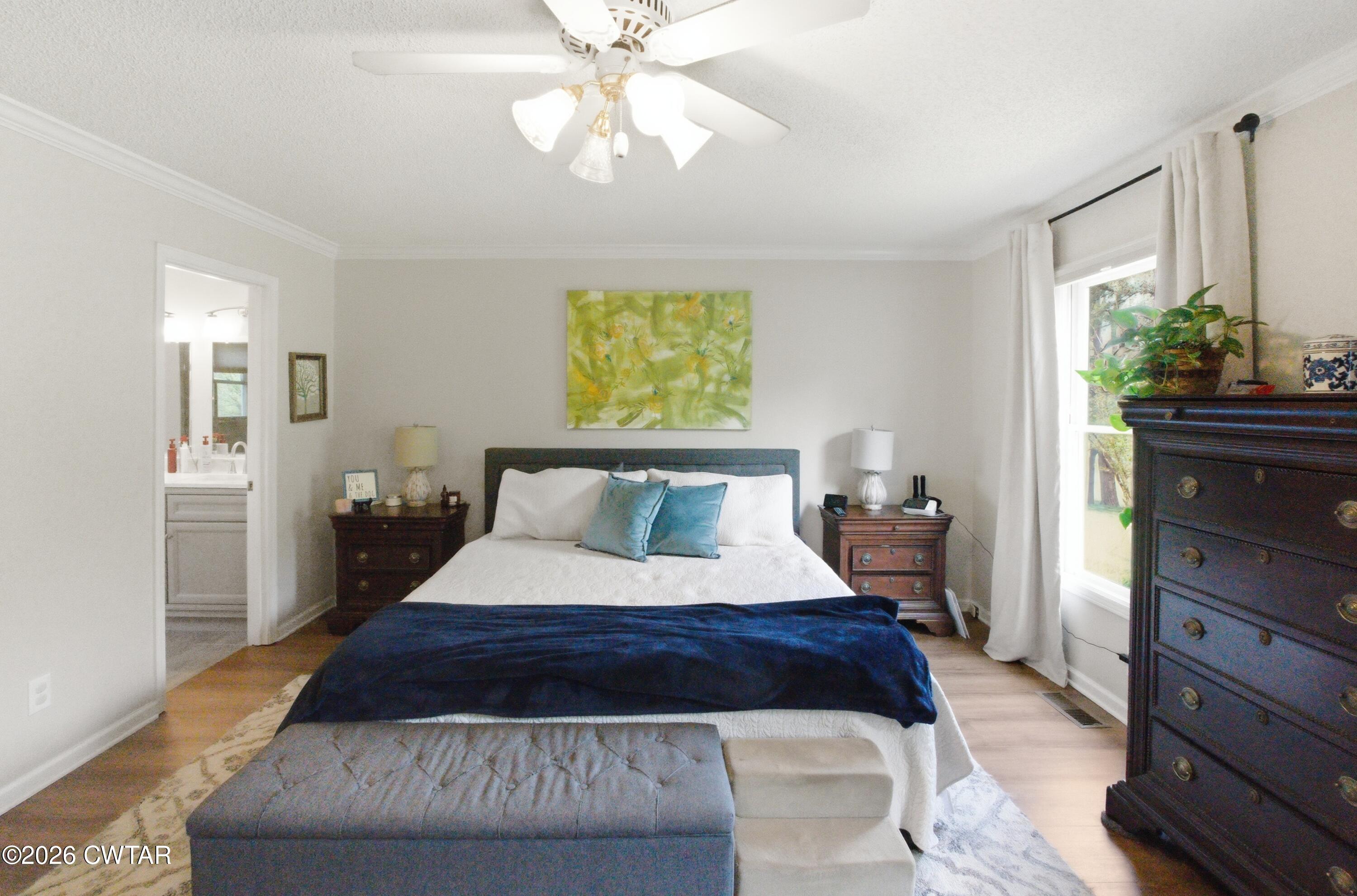2757 Edward Williams Road Gadsden, TN 38337 - Photo 35 of 51 a bedroom with a large bed and a chandelier