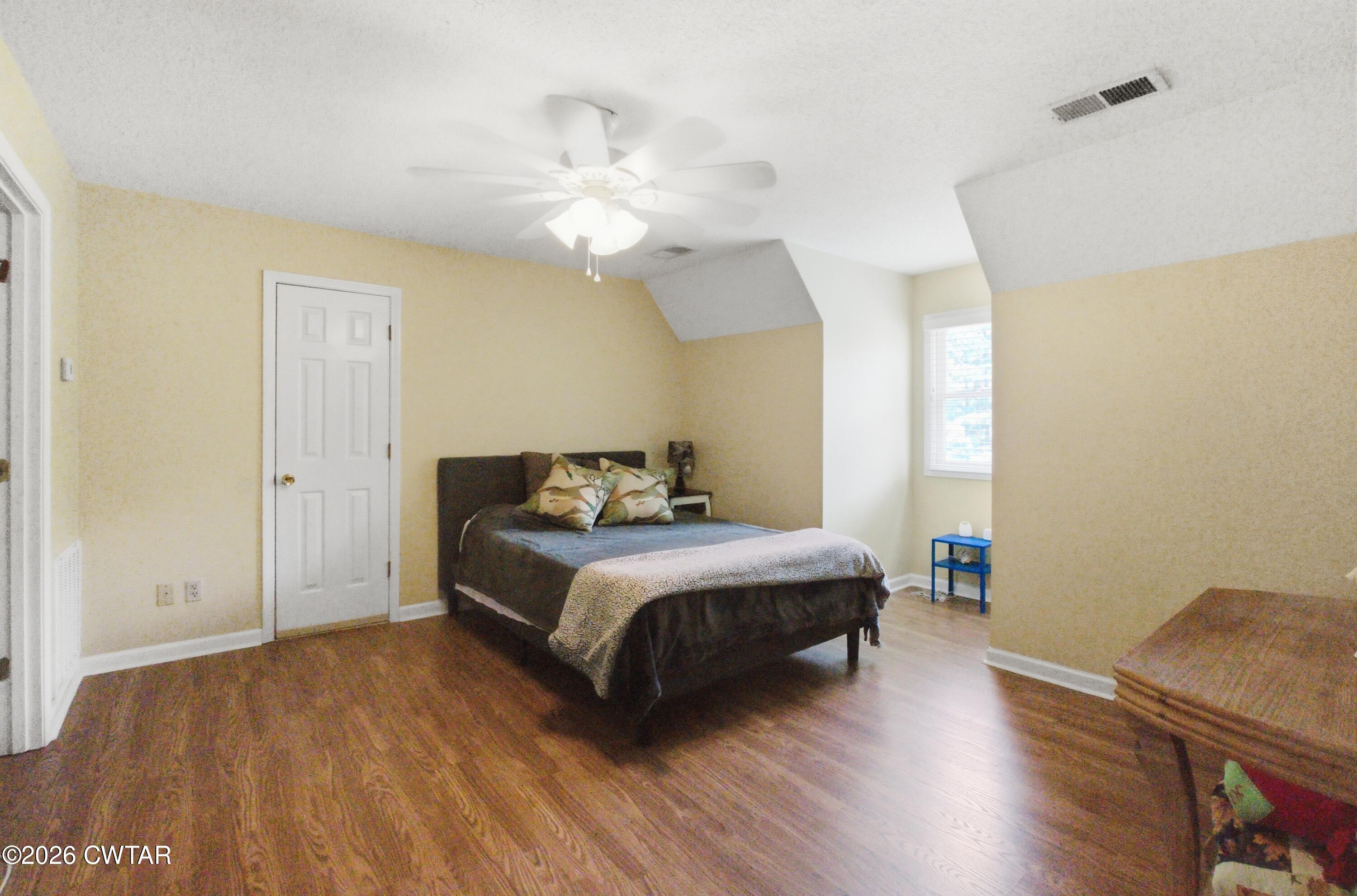 2757 Edward Williams Road Gadsden, TN 38337 - Photo 42 of 51 a spacious bedroom with a bed and wooden floor