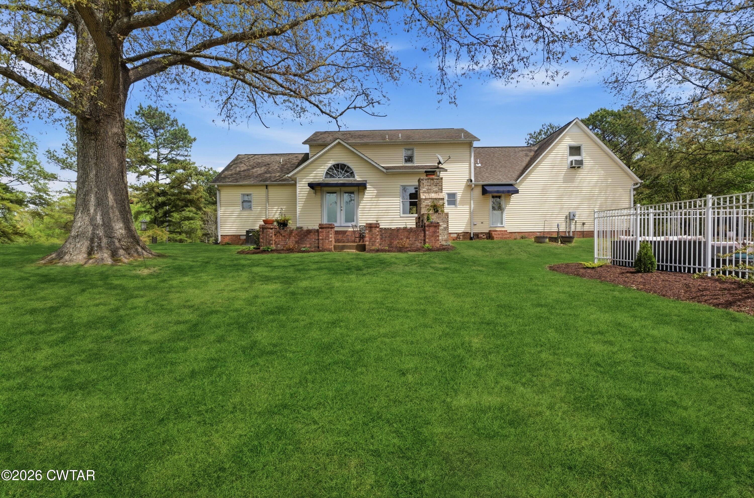 2757 Edward Williams Road Gadsden, TN 38337 - Photo 45 of 51 a view of a white house with a big yard and large tree