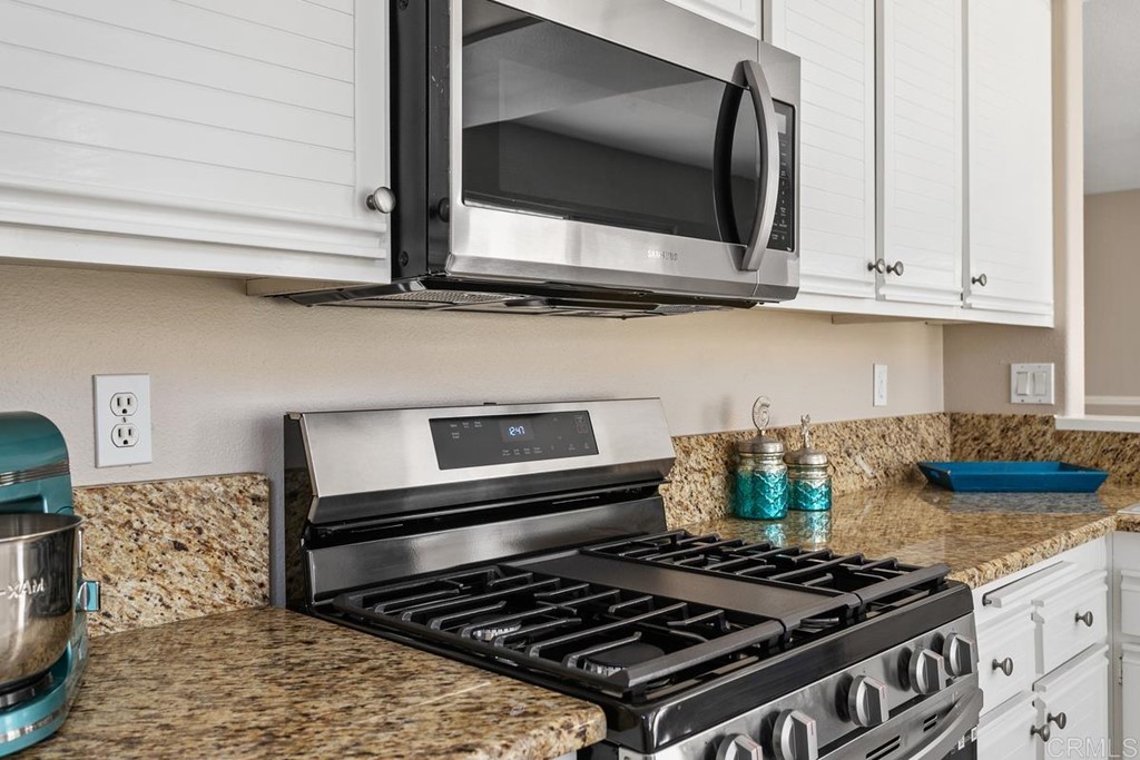 1865 Ithaca Drive Vista, CA 92081 - Photo 14 of 31 a stove top oven sitting inside of a kitchen