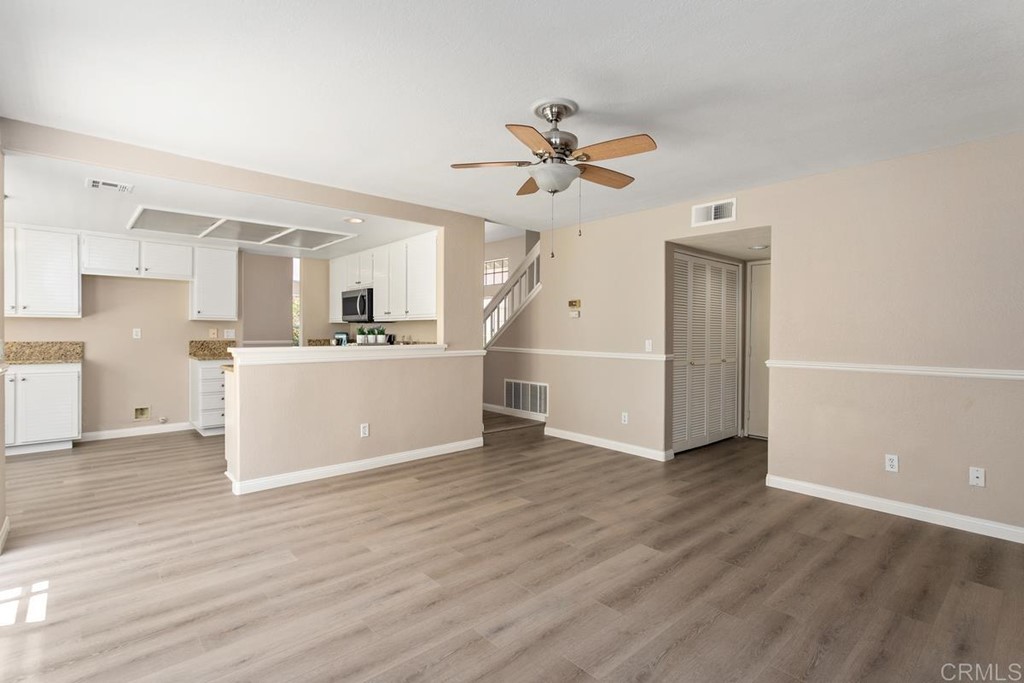 1865 Ithaca Drive Vista, CA 92081 - Photo 19 of 31 a view of a kitchen with wooden floor and a ceiling fan