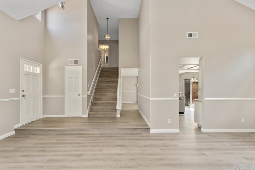 1865 Ithaca Drive Vista, CA 92081 - Photo 7 of 31 a view of a hallway with wooden floor and staircase
