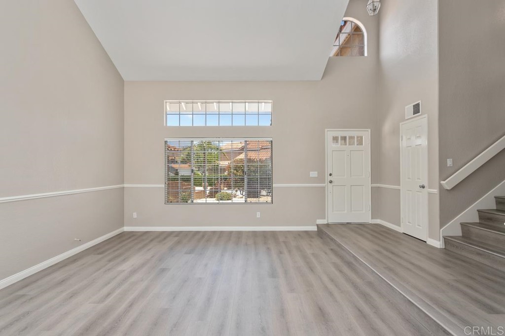 1865 Ithaca Drive Vista, CA 92081 - Photo 8 of 31 an empty room with wooden floor and windows
