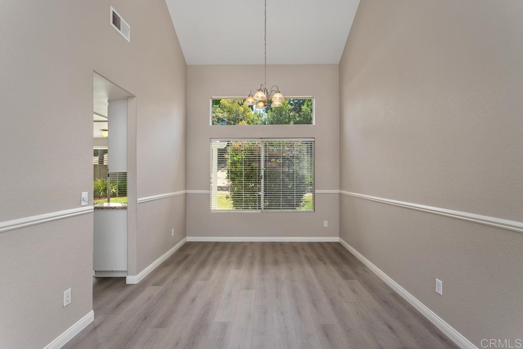 1865 Ithaca Drive Vista, CA 92081 - Photo 9 of 31 wooden floor in an empty room with a window