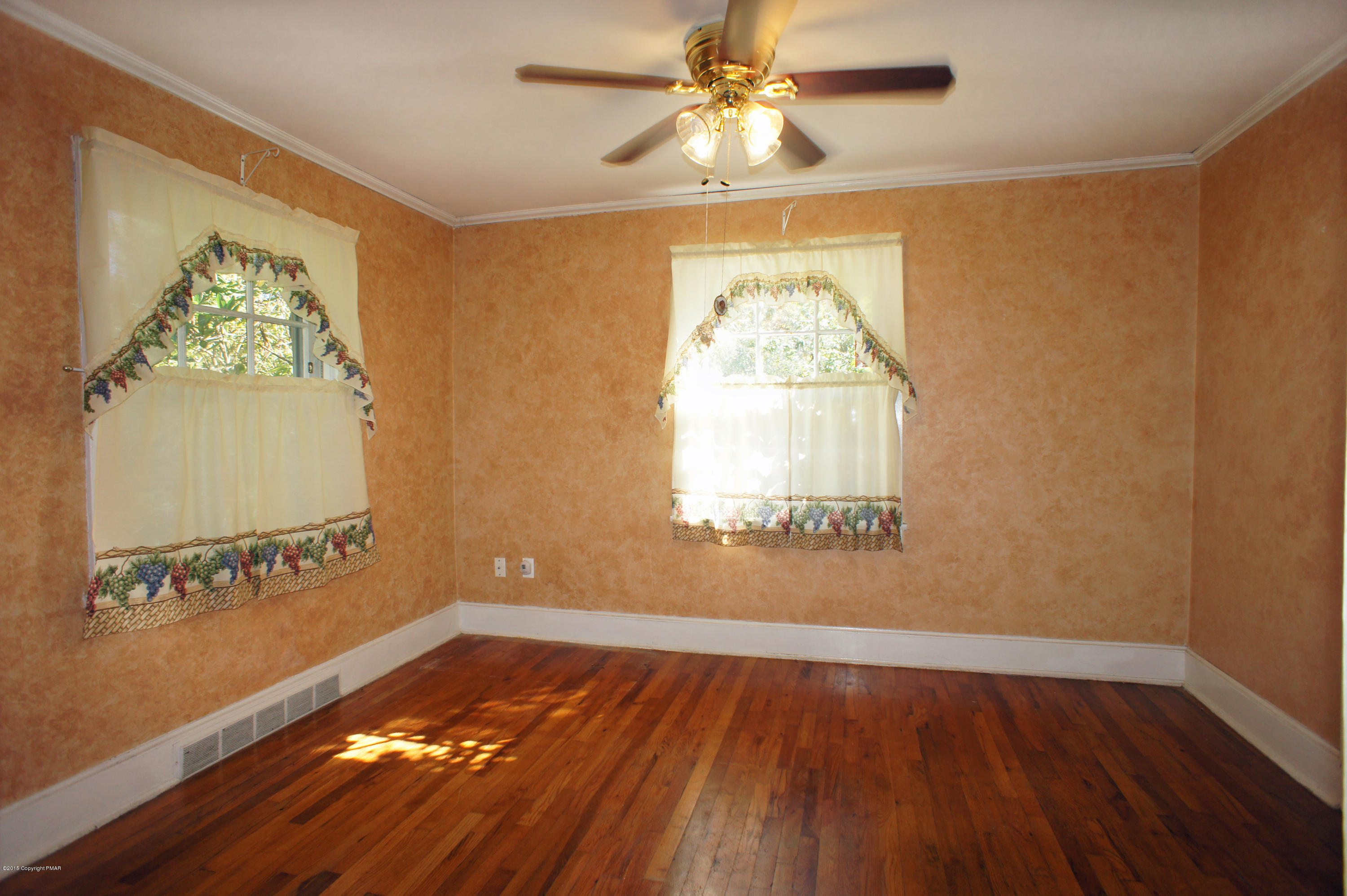 177 Tanite Road Stroudsburg, PA 18360 - Photo 9 of 30 a view of empty room with wooden floor and fan