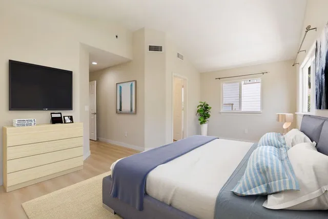 a bedroom with a bed and a flat screen tv