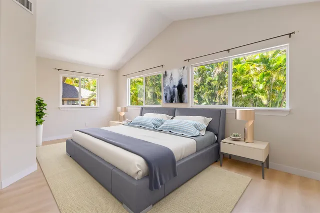 a bedroom with a bed and a large window