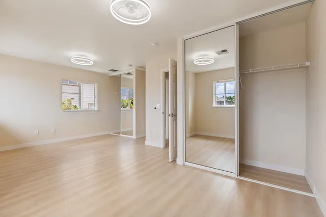 an empty room with windows and closet