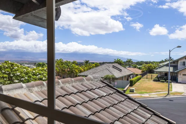 a view of a city with couches and a table and chairs