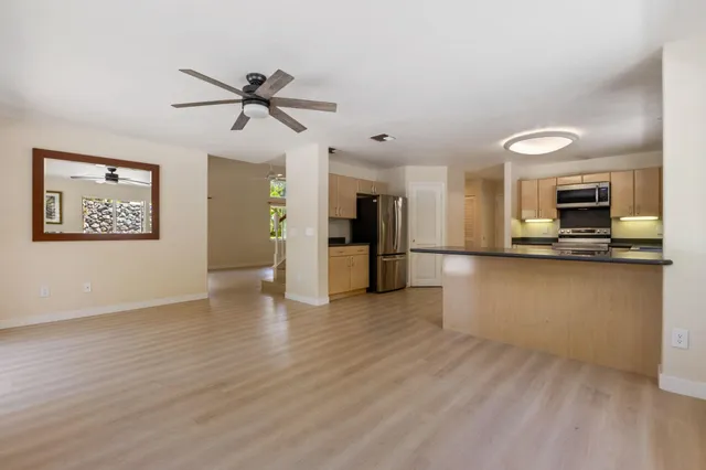 a view of a kitchen with a microwave and furniture