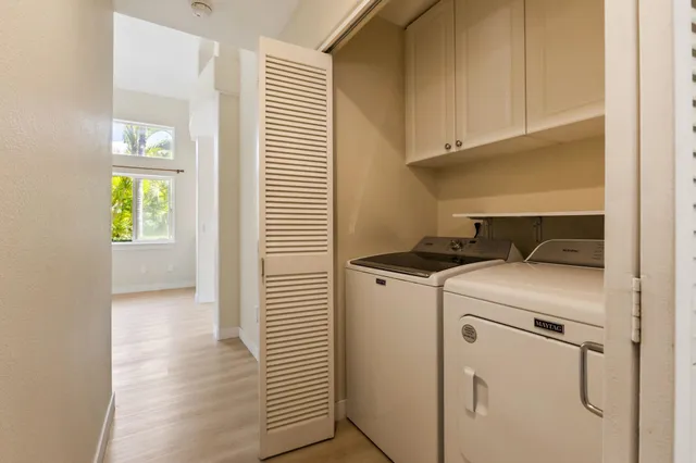 a utility room with closet dryer and washer