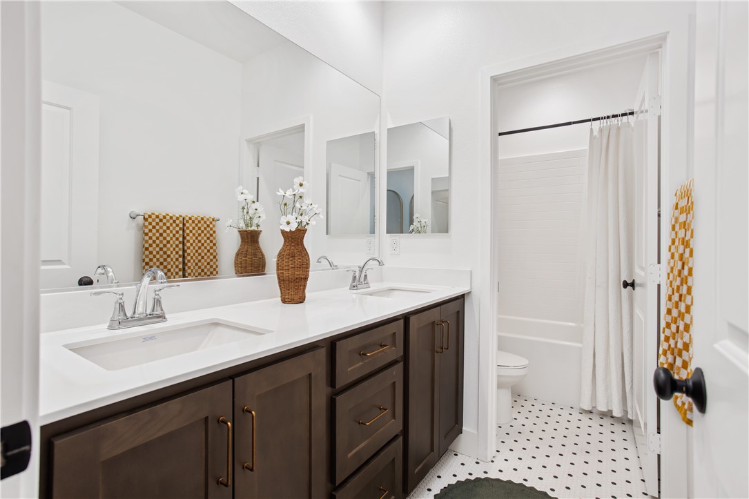32207 Penstemon Way Temecula, CA 92591 - Photo 14 of 33 a bathroom with a sink a toilet and shower