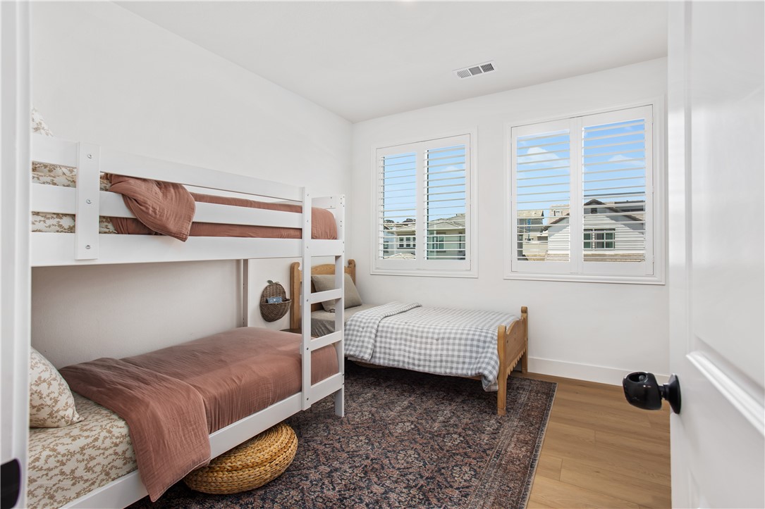 32207 Penstemon Way Temecula, CA 92591 - Photo 15 of 33 a bedroom with a bed and wooden floor