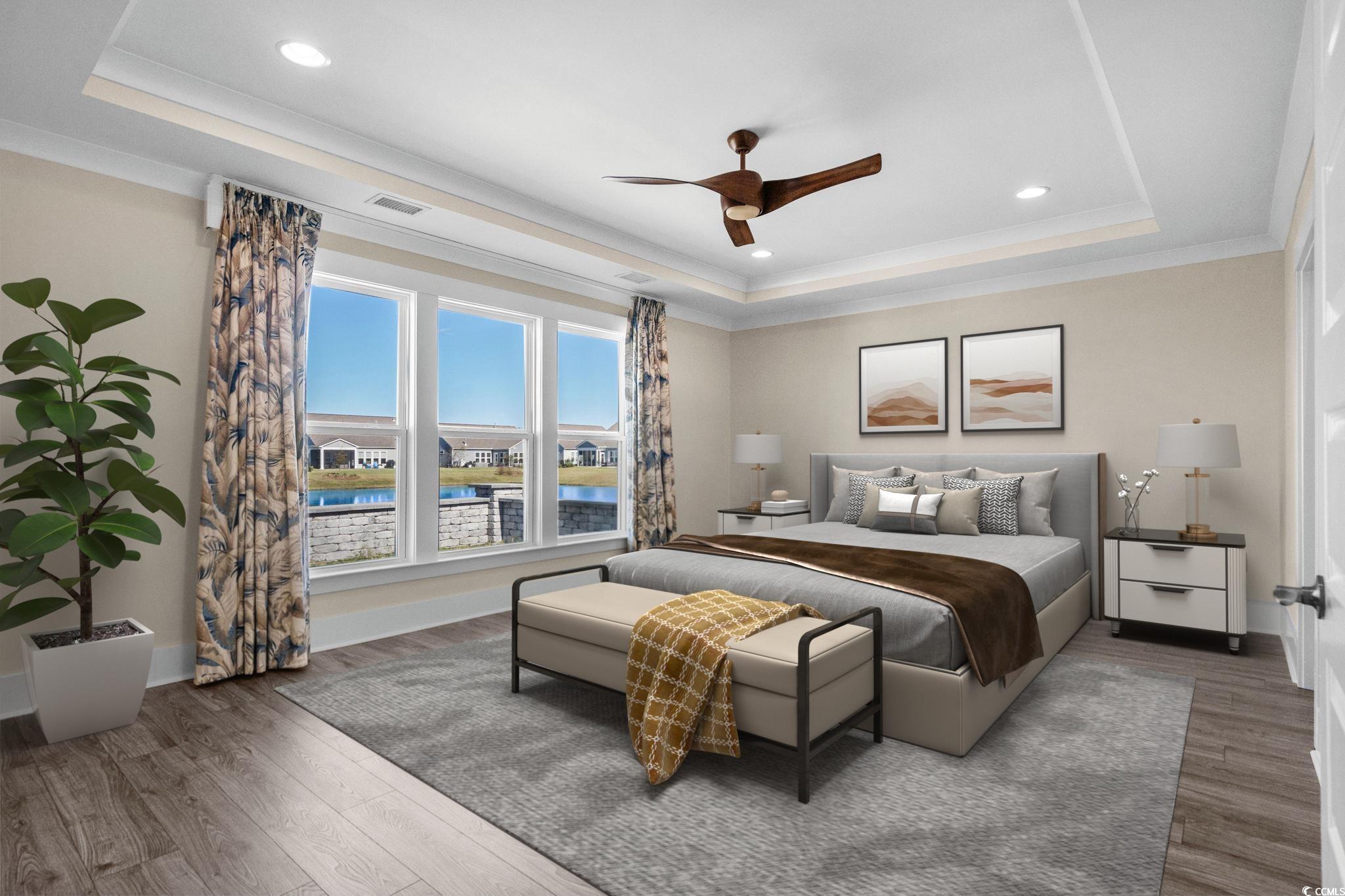 7129 Spoleto Drive Myrtle Beach, SC 29572 - Photo 19 of 39 Bedroom featuring a raised ceiling, a water view, a ceiling fan, recessed lighting, and wood finished floors