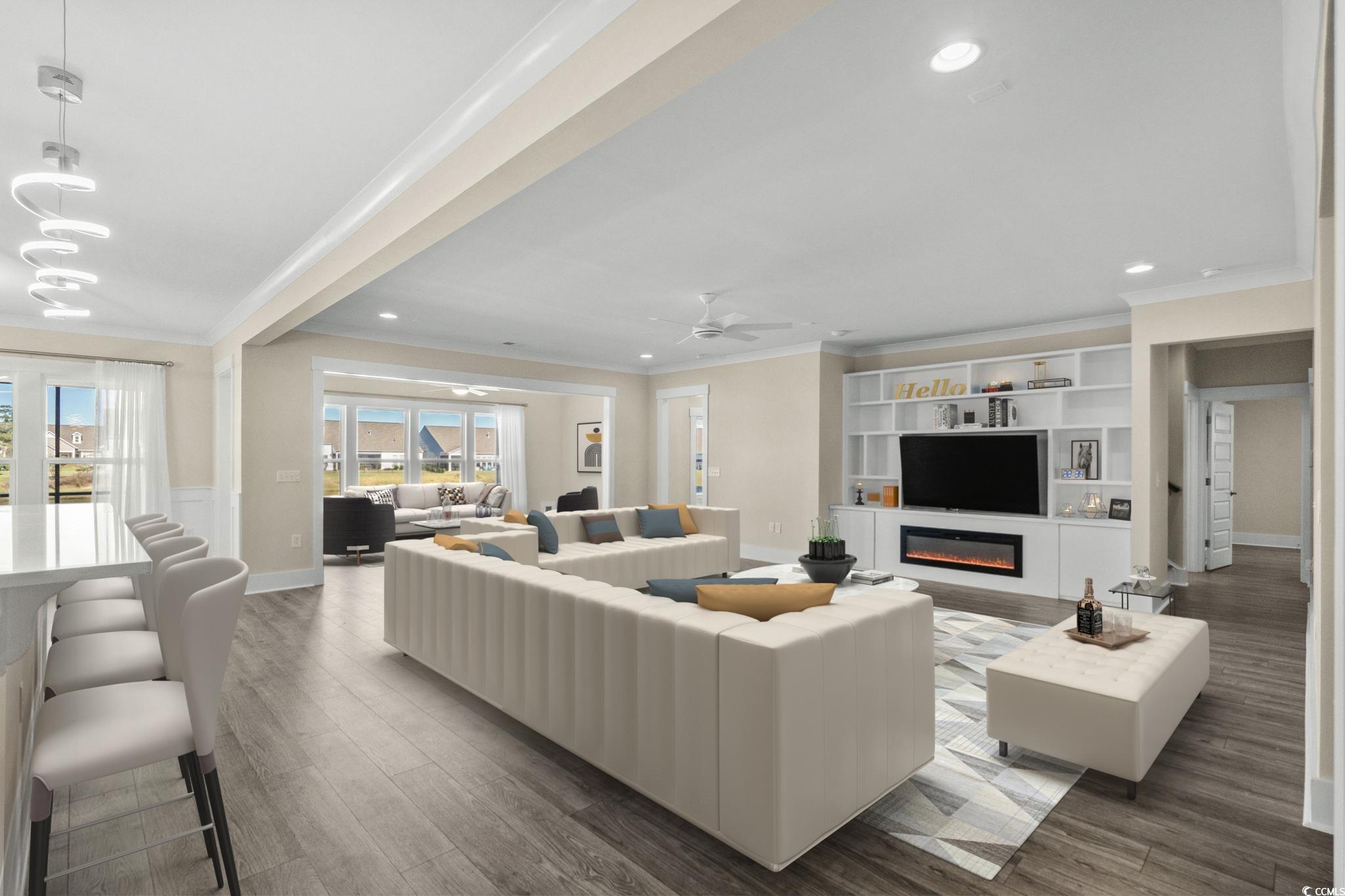 7129 Spoleto Drive Myrtle Beach, SC 29572 - Photo 6 of 39 Living area with wood finished floors, recessed lighting, a glass covered fireplace, ceiling fan, and ornamental molding