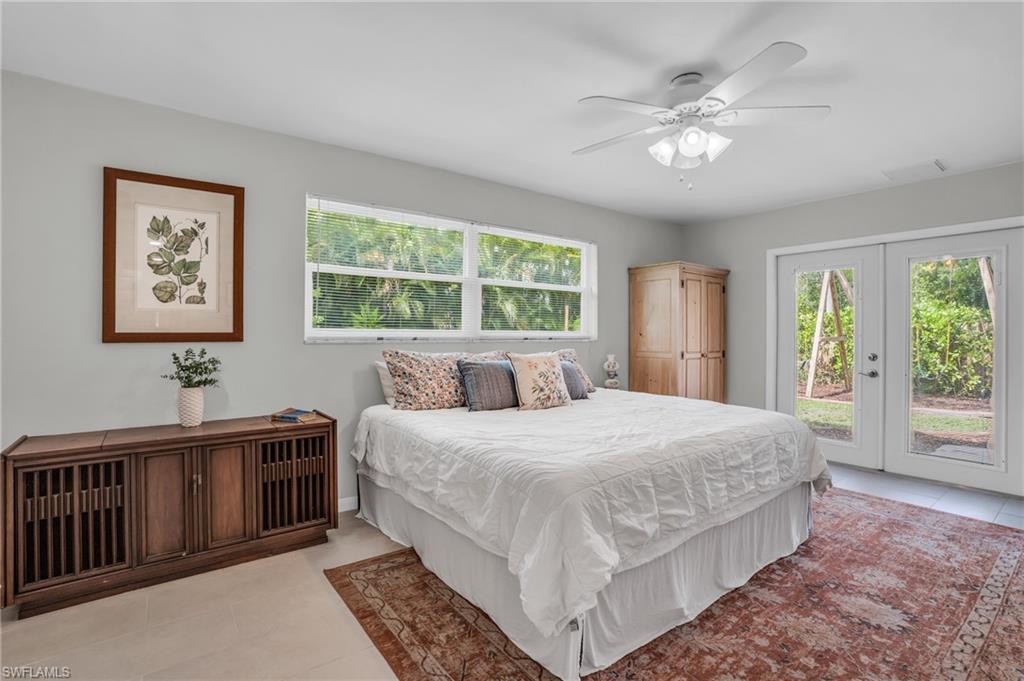 2905 Sunset Road Fort Myers, FL 33901 - Photo 14 of 18 a bedroom with a large bed and a chandelier