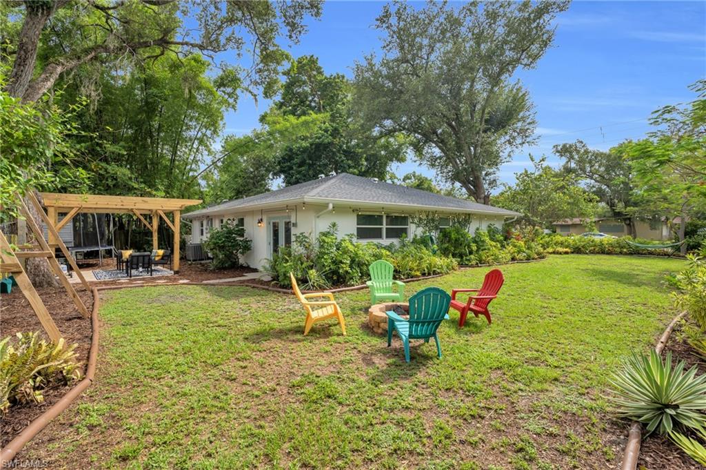 2905 Sunset Road Fort Myers, FL 33901 - Photo 4 of 18 a view of a patio with table and chairs under an umbrella