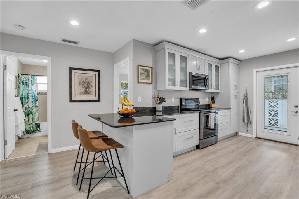 2905 Sunset Road Fort Myers, FL 33901 - Photo 7 of 18 a kitchen with white cabinets and appliances