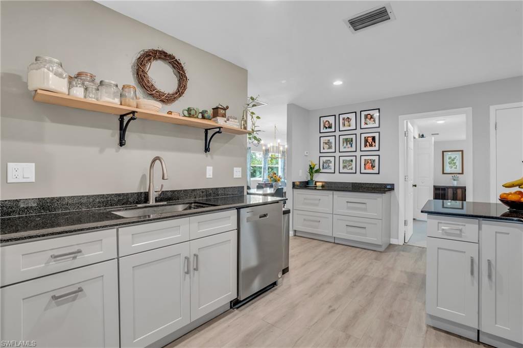 2905 Sunset Road Fort Myers, FL 33901 - Photo 9 of 18 a kitchen with granite countertop a white cabinets and sink