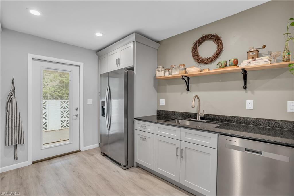 2905 Sunset Road Fort Myers, FL 33901 - Photo 10 of 18 a kitchen with a sink a refrigerator and wooden floor