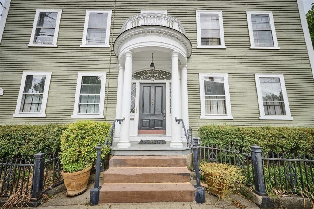 a front view of a house with a garden