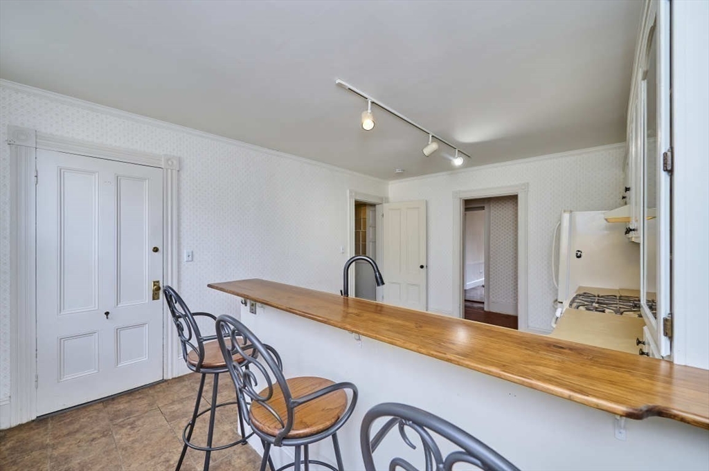 74 Washington Square, Unit 2 Salem, MA 01970 - Photo 12 of 31 a kitchen with stainless steel appliances granite countertop a sink and cabinets