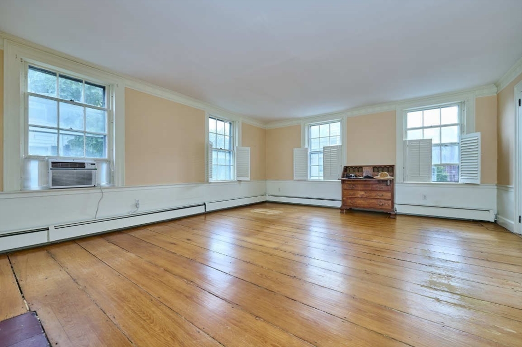 74 Washington Square, Unit 2 Salem, MA 01970 - Photo 14 of 31 a view of empty room with wooden floor and fan