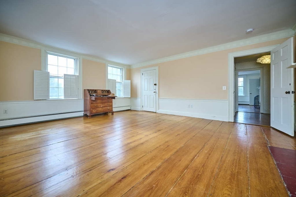 74 Washington Square, Unit 2 Salem, MA 01970 - Photo 15 of 31 an empty room with wooden floor and windows