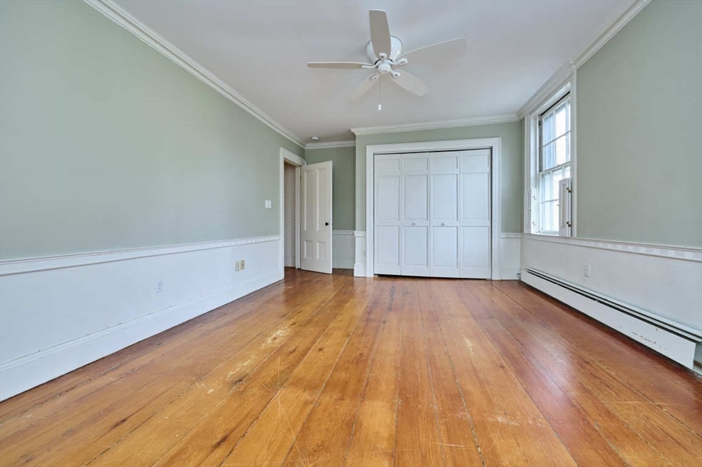 74 Washington Square, Unit 2 Salem, MA 01970 - Photo 16 of 31 wooden floor in an empty room with a window