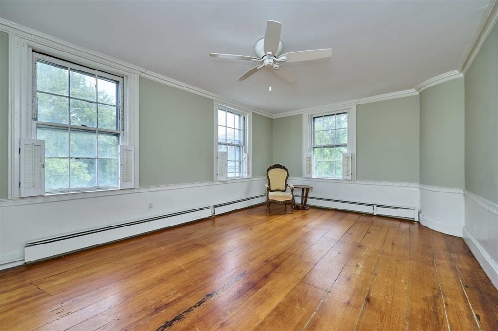 74 Washington Square, Unit 2 Salem, MA 01970 - Photo 17 of 31 an empty room with wooden floor fan and windows