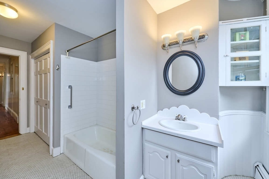 74 Washington Square, Unit 2 Salem, MA 01970 - Photo 19 of 31 a bathroom with a sink a toilet and a mirror