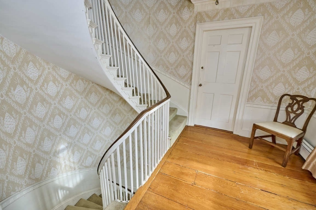 74 Washington Square, Unit 2 Salem, MA 01970 - Photo 22 of 31 a view of a hallway with wooden floor and stairs