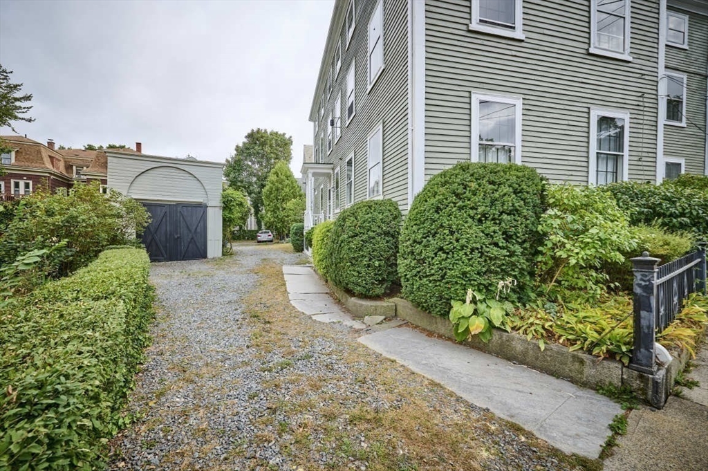 74 Washington Square, Unit 2 Salem, MA 01970 - Photo 26 of 31 a front view of a house with a yard and potted plants