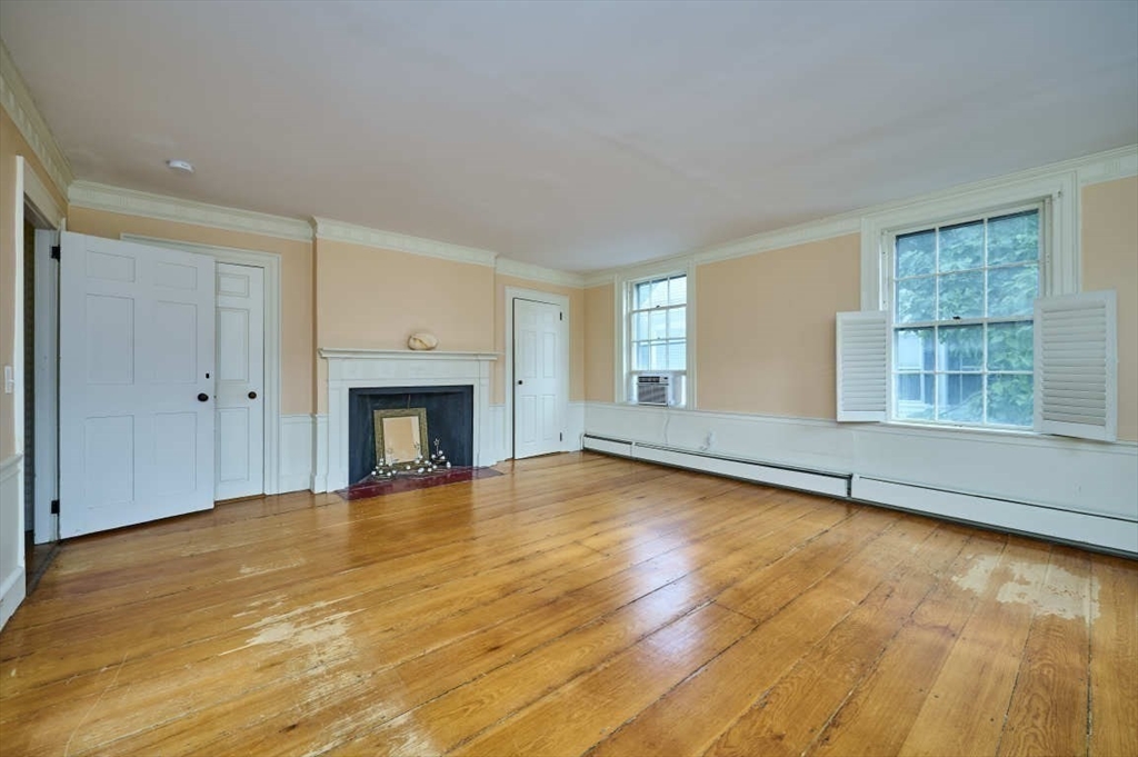 74 Washington Square, Unit 2 Salem, MA 01970 - Photo 8 of 31 a view of an empty room with a window and wooden floor