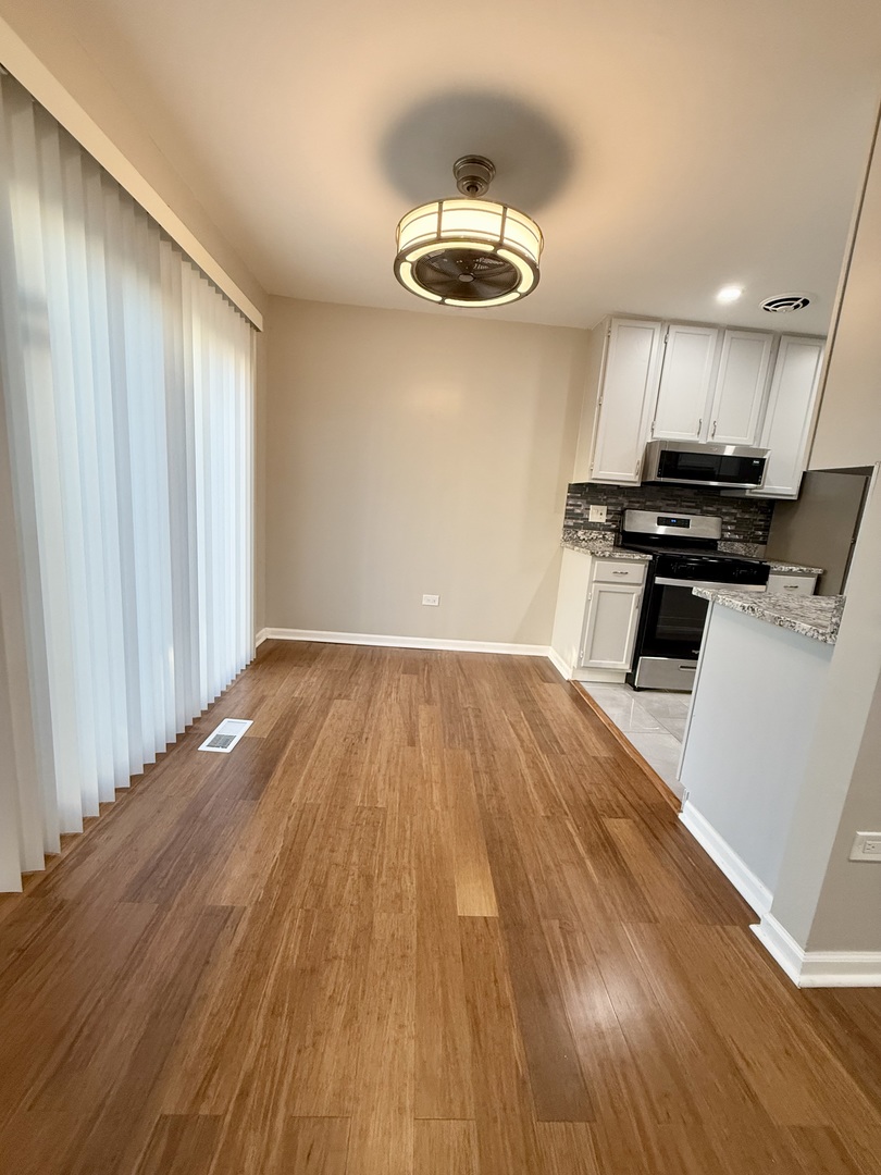 1045 Hampton Harbor, Unit 1045 Schaumburg, IL 60193 - Photo 4 of 18 a view of a room with wooden floor