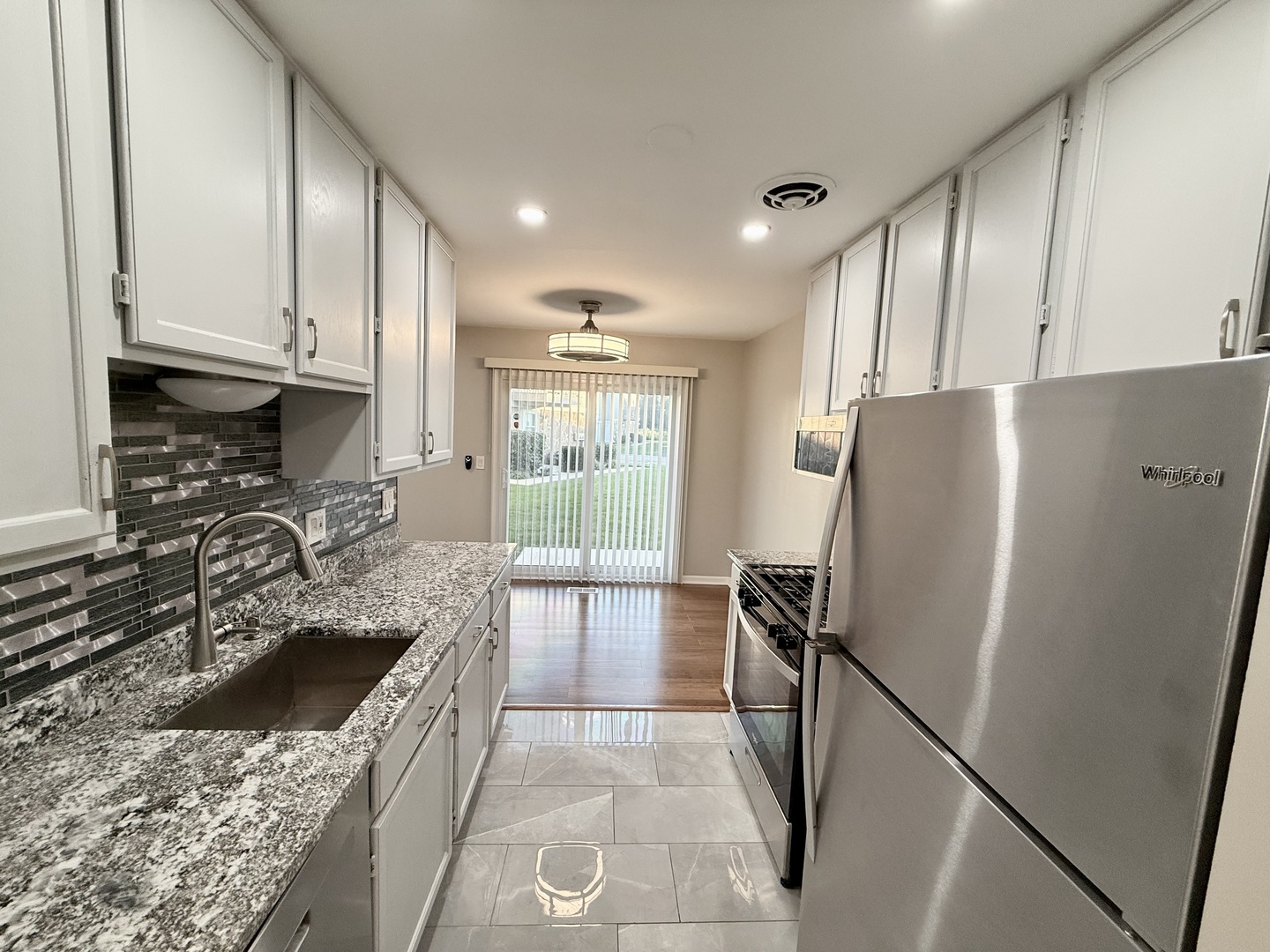 1045 Hampton Harbor, Unit 1045 Schaumburg, IL 60193 - Photo 7 of 18 a kitchen with a refrigerator sink and stove
