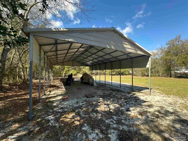 a view of side of a yard with trees