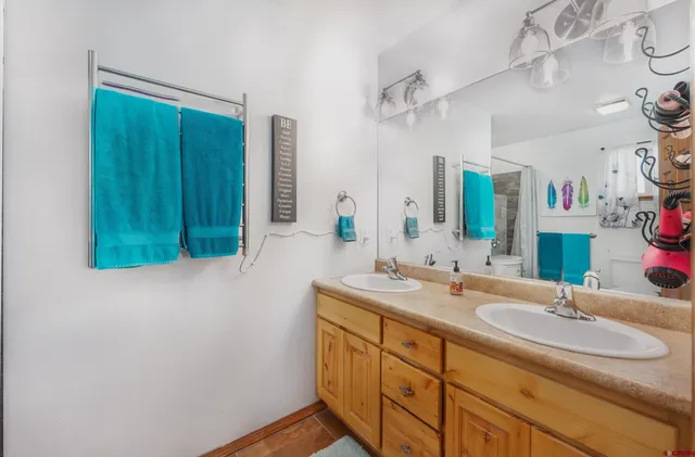 a bathroom with a double vanity sink and a mirror