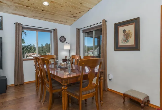 a view of a dining room with furniture and window