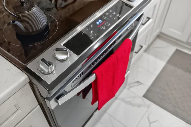 a kitchen with stainless steel appliances kitchen island granite countertop a sink and cabinets
