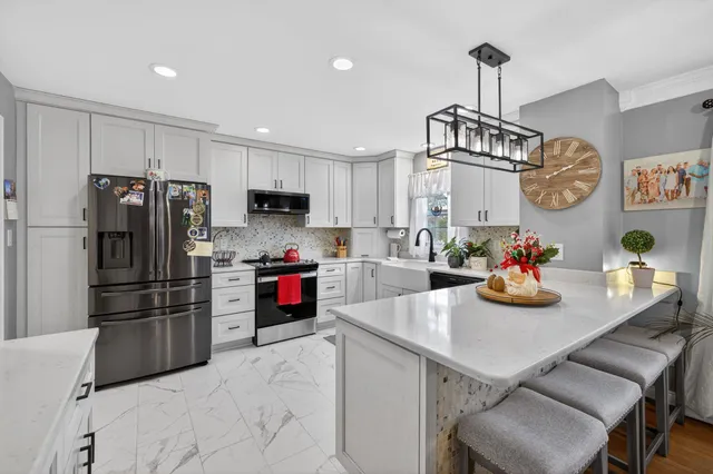 a kitchen that has a lot of cabinets and refrigerator