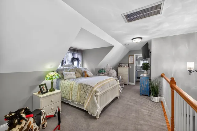 a living room with furniture a rug and a floor to ceiling window