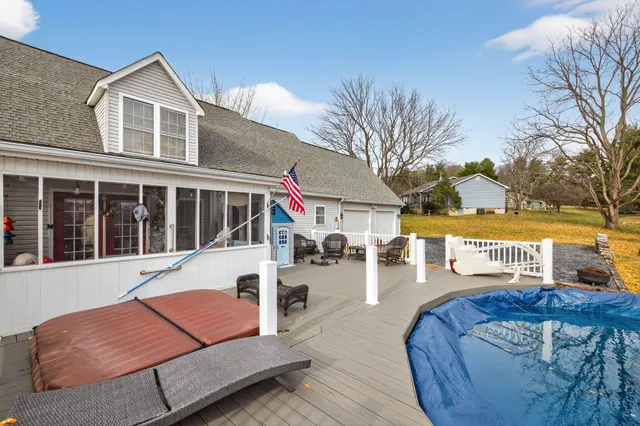 a view of a house with a big yard and large trees