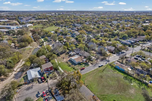 an aerial view of residential houses with city view
