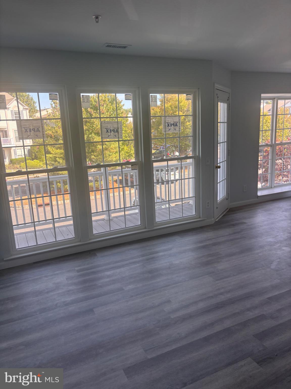 265 Rosebay Court Delran, NJ 08075 - Photo 2 of 17 a view of an empty room with wooden floor and a window