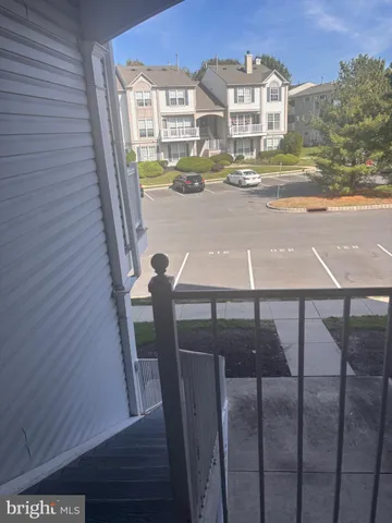 a view of balcony with two chairs and wooden floor